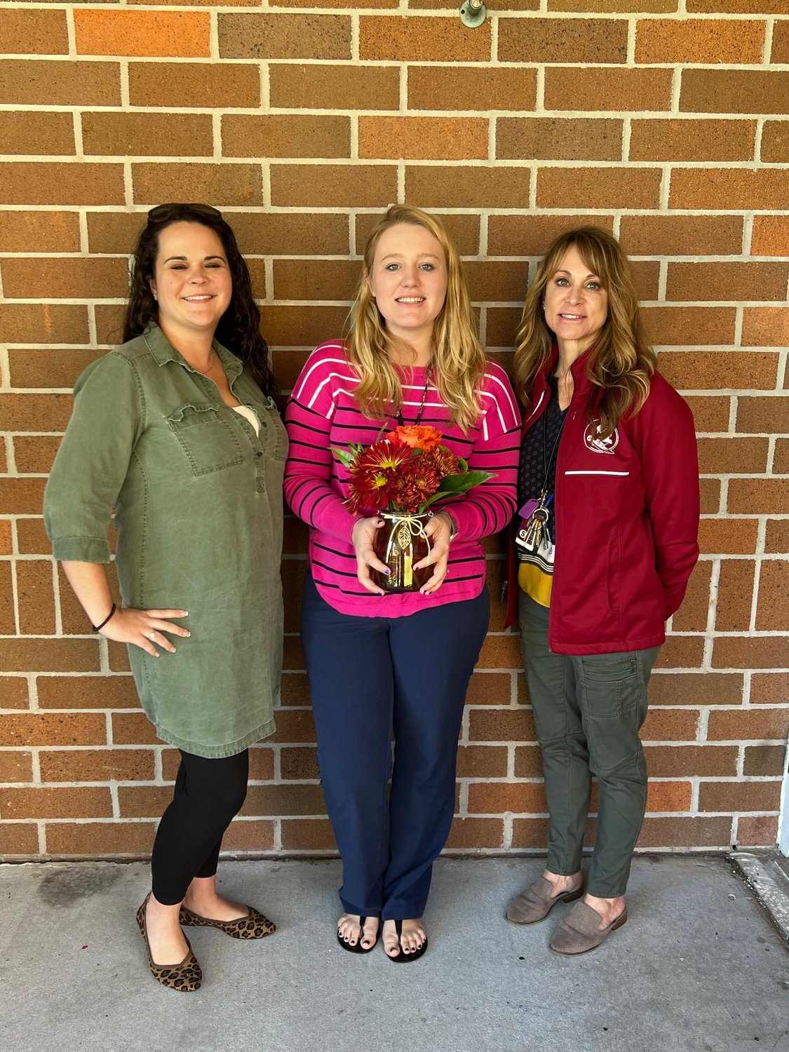 Assistant principal Sonya Vandermolen (left) and principal Robyn Ziolkowski (right) congratulate Project ONE new teacher of the year Audrey Greseth.